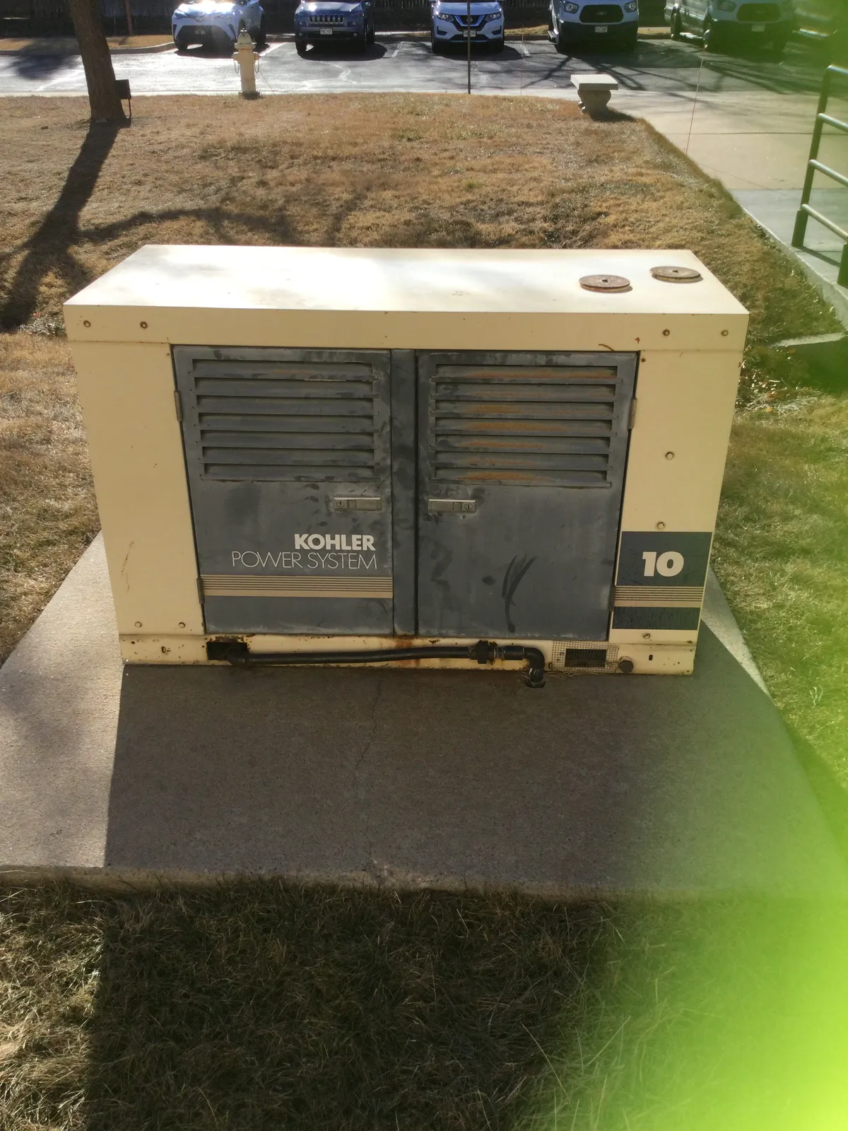 Home standby generator on its pad beside a house, Northern Colorado